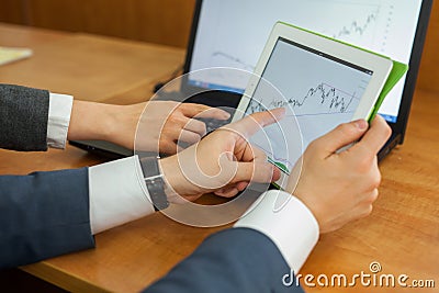 The close-up of diagram on the tablet in manâ€™s hands. Stock Photo